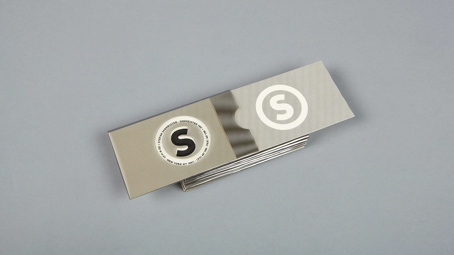 Sagmeister's business cards. Text is masked until the card is removed from the holder